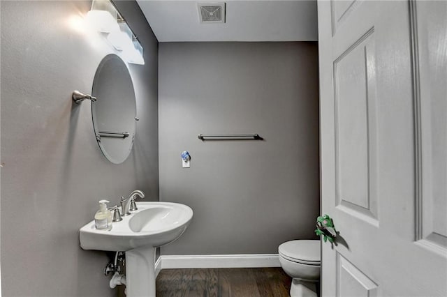2515 Gadsen Walk, Duluth, GA 30097 - half bathroom with toilet and wood finished floors