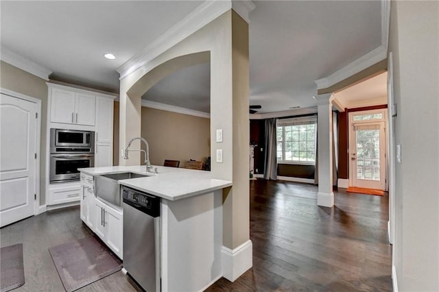 2515 Gadsen Walk, Duluth, GA 30097 - kitchen featuring stainless steel appliances, ornamental molding, light countertops, white cabinets, and dark wood-type flooring