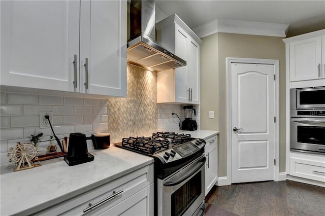 2515 Gadsen Walk, Duluth, GA 30097 - kitchen featuring wall chimney range hood, stainless steel appliances, dark wood-type flooring, white cabinets, and decorative backsplash