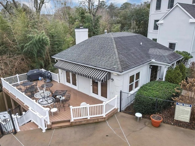 rear view of house with a fire pit and a deck