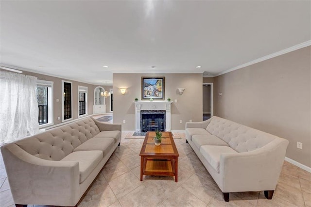 living area with light tile patterned floors, baseboards, crown molding, a fireplace, and a notable chandelier