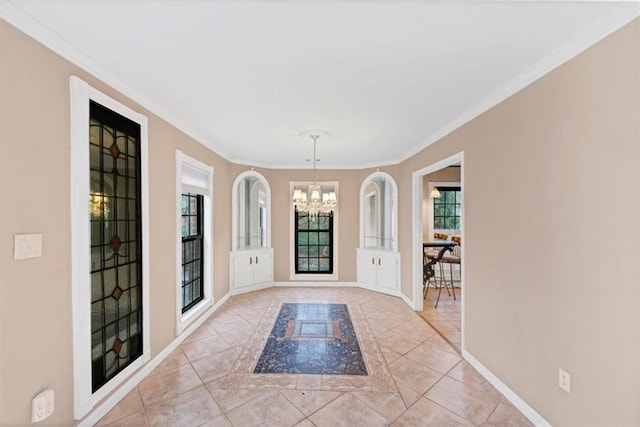 entryway with light tile patterned floors, crown molding, and a chandelier