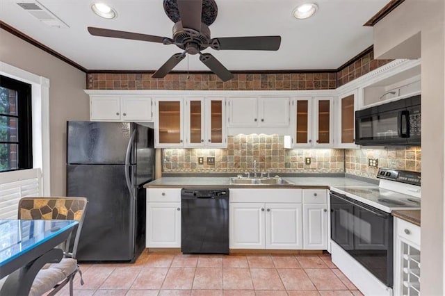 kitchen with white cabinets, light tile patterned floors, sink, and black appliances