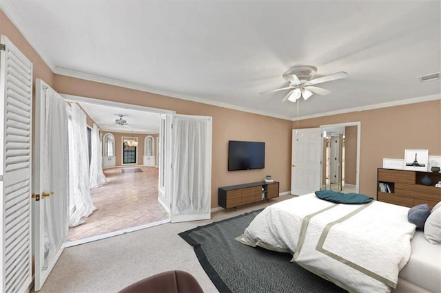 bedroom with light carpet, ornamental molding, and ceiling fan