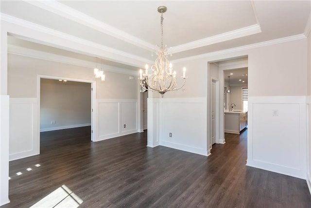 unfurnished dining area with sink, dark hardwood / wood-style floors, and a tray ceiling