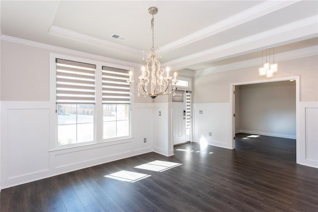 unfurnished dining area with crown molding, dark wood-type flooring, a notable chandelier, and a tray ceiling