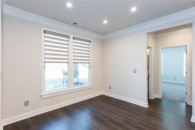 empty room featuring dark hardwood / wood-style flooring and crown molding