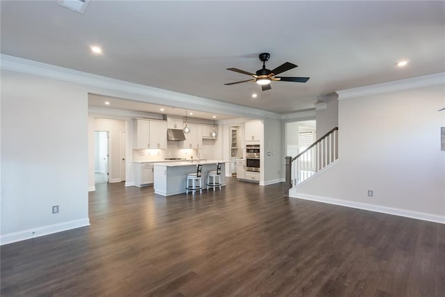 unfurnished living room with ornamental molding, dark hardwood / wood-style floors, and ceiling fan