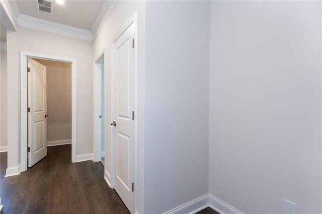 hall with ornamental molding and dark hardwood / wood-style floors