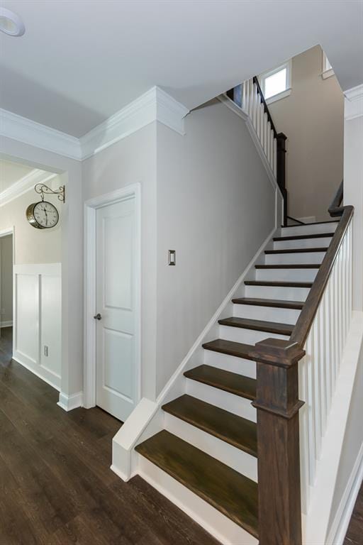 stairs with hardwood / wood-style flooring and crown molding