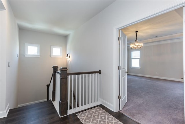 stairs with hardwood / wood-style flooring and a notable chandelier