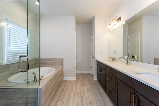 bathroom featuring vanity and tiled tub