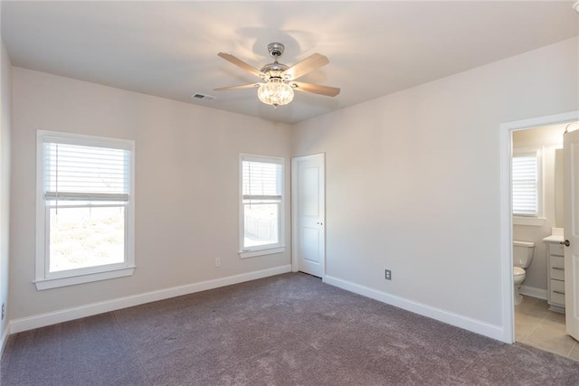 unfurnished room with light colored carpet and ceiling fan