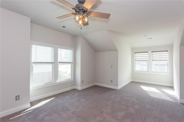 additional living space featuring lofted ceiling, carpet floors, and ceiling fan