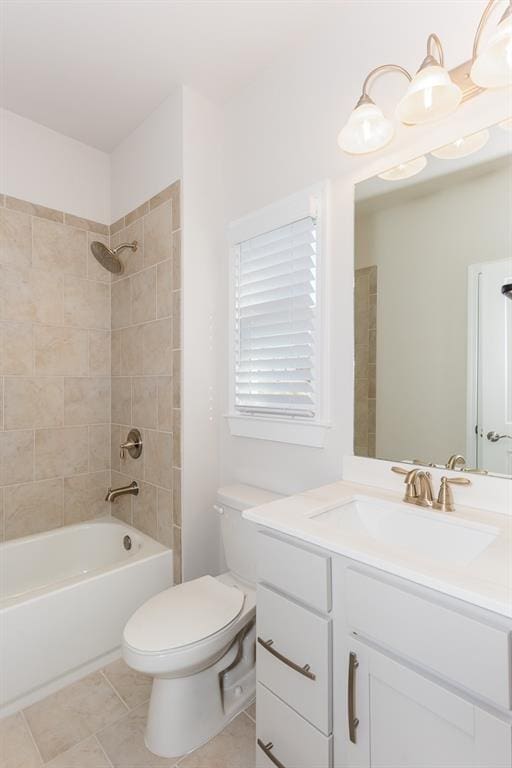 full bathroom featuring tiled shower / bath, vanity, tile patterned floors, and toilet