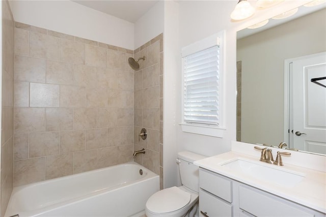 full bathroom with tiled shower / bath combo, vanity, and toilet