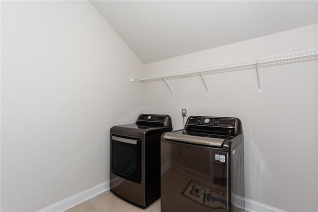 laundry room featuring light tile patterned floors and washing machine and clothes dryer