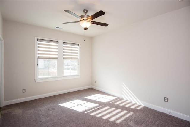 carpeted spare room with ceiling fan