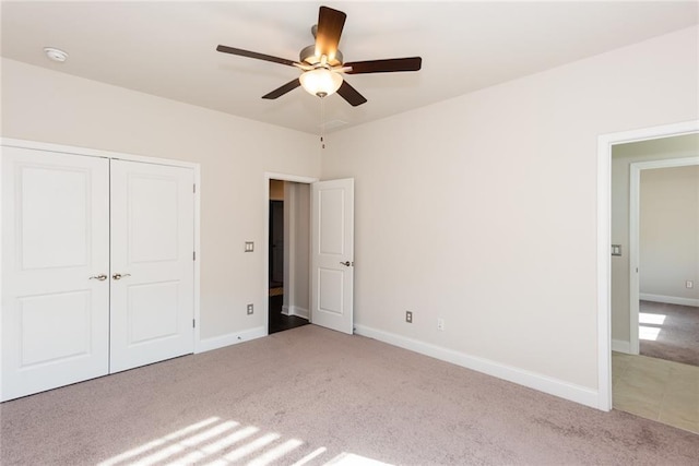 unfurnished bedroom with carpet, ceiling fan, and a closet