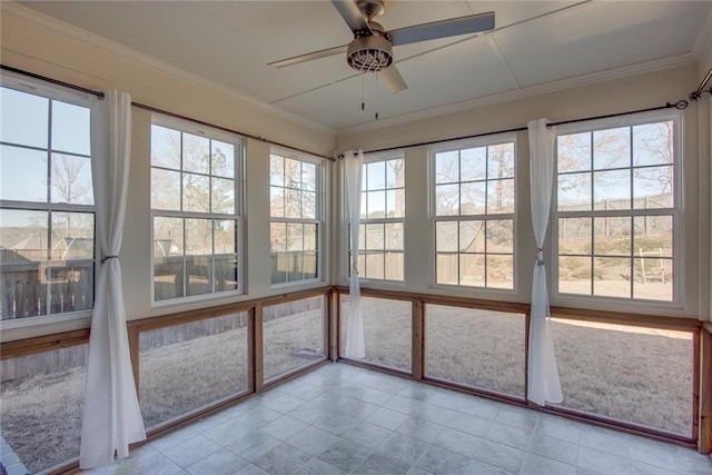 unfurnished sunroom featuring a healthy amount of sunlight and ceiling fan