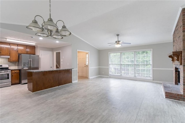803 Cedar Lake Dr SE, Conyers, GA 30094 - unfurnished living room with vaulted ceiling, a chandelier, light wood-type flooring, ceiling fan, and a brick fireplace