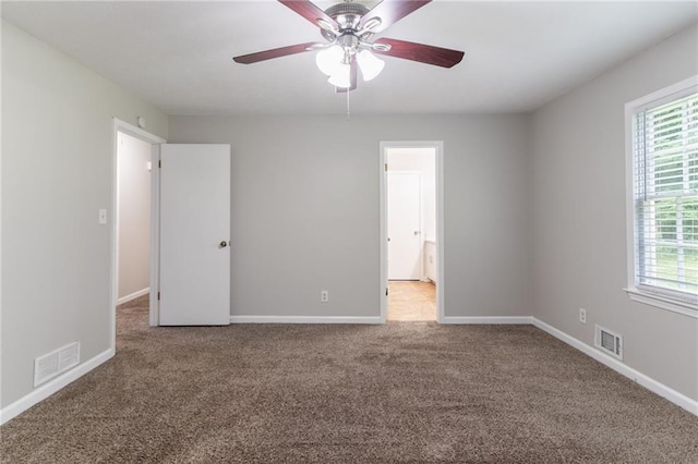 803 Cedar Lake Dr SE, Conyers, GA 30094 - carpeted empty room featuring plenty of natural light, a ceiling fan, and baseboards