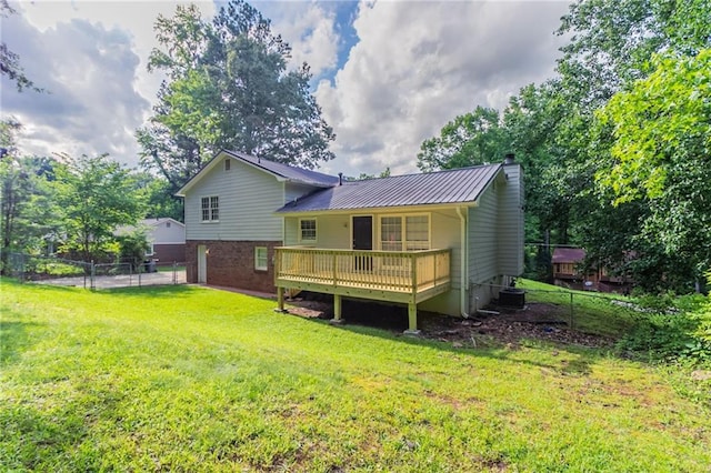 803 Cedar Lake Dr SE, Conyers, GA 30094 - back of property with a wooden deck, metal roof, central AC unit, a chimney, and brick siding