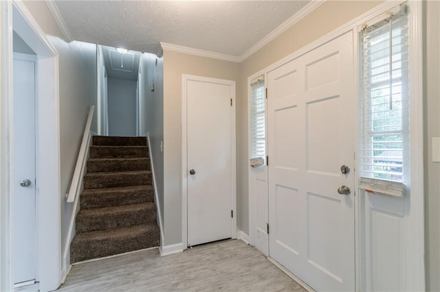 803 Cedar Lake Dr SE, Conyers, GA 30094 - foyer featuring light wood-type flooring, a textured ceiling, ornamental molding, baseboards, and stairs