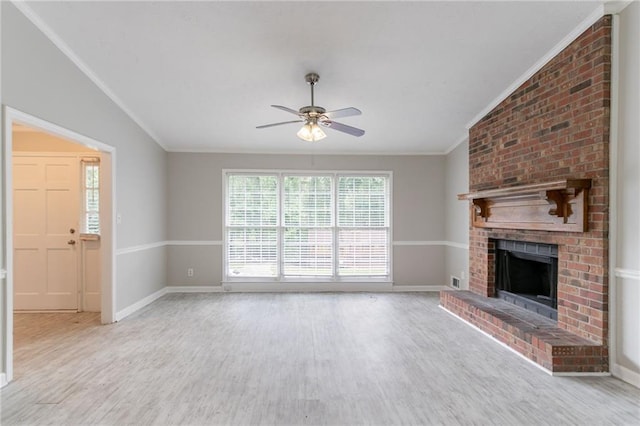 803 Cedar Lake Dr SE, Conyers, GA 30094 - unfurnished living room featuring crown molding, ceiling fan, a brick fireplace, wood finished floors, and baseboards