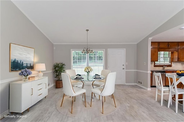 803 Cedar Lake Dr SE, Conyers, GA 30094 - dining space featuring light wood-type flooring, a chandelier, baseboards, and crown molding