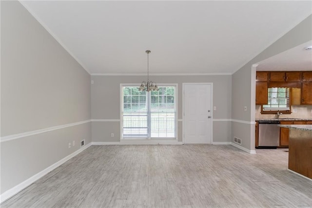 803 Cedar Lake Dr SE, Conyers, GA 30094 - unfurnished dining area with a chandelier, light wood-style floors, baseboards, healthy amount of natural light, and ornamental molding