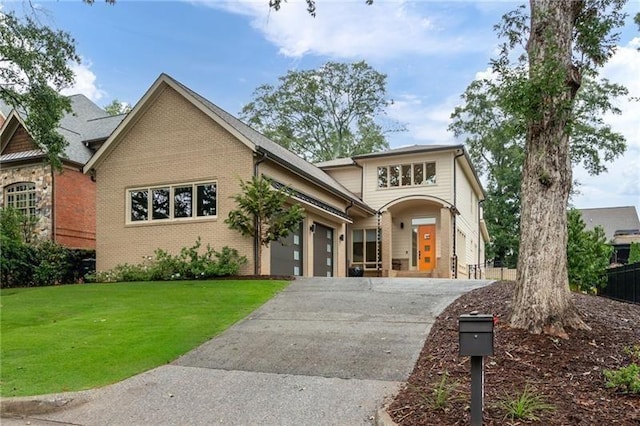 view of front of home with a front yard and a garage