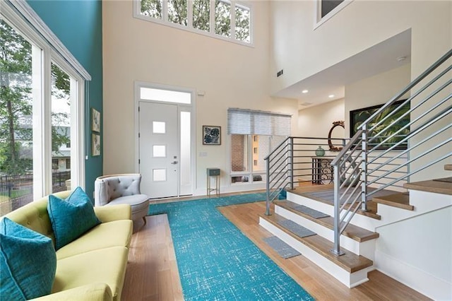 interior space featuring a high ceiling and wood-type flooring