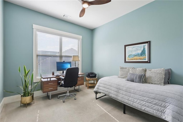 bedroom featuring visible vents, baseboards, ceiling fan, and light carpet