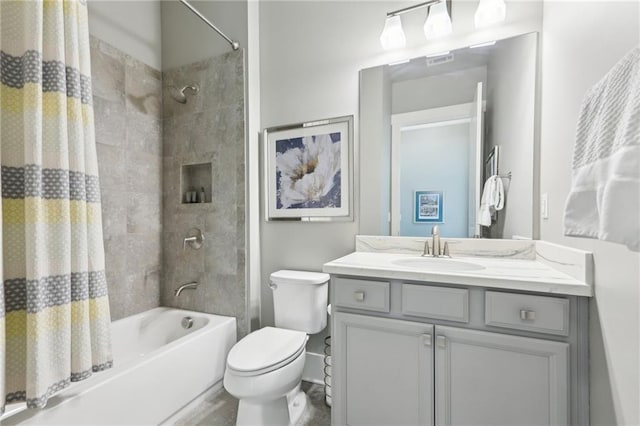 bathroom with vanity, shower / bath combo, toilet, and visible vents