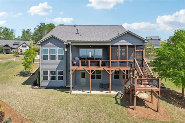 back of property featuring a sunroom, a patio area, a lawn, and a deck