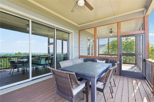 sunroom with ceiling fan and outdoor dining area