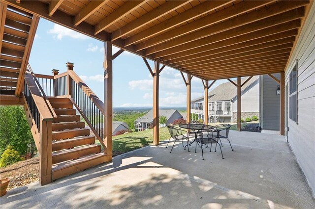 back of house with fence, a sunroom, stairway, a patio area, and a yard