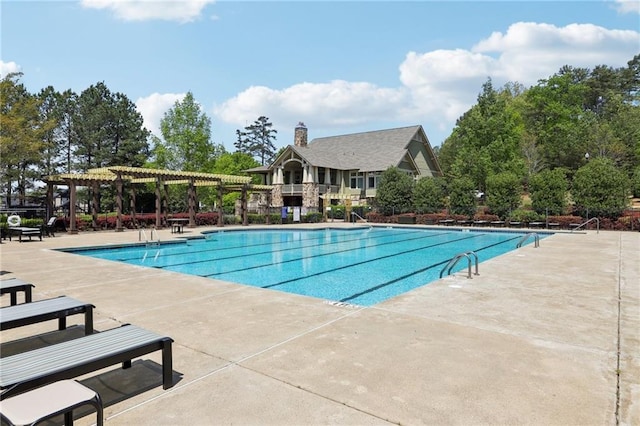 pool featuring a pergola and a patio