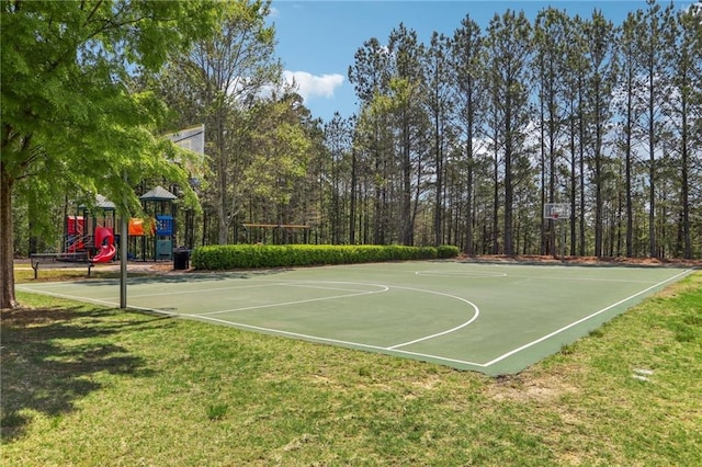 view of sport court with a lawn, community basketball court, and playground community