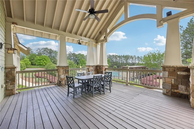 deck featuring outdoor dining area and a ceiling fan