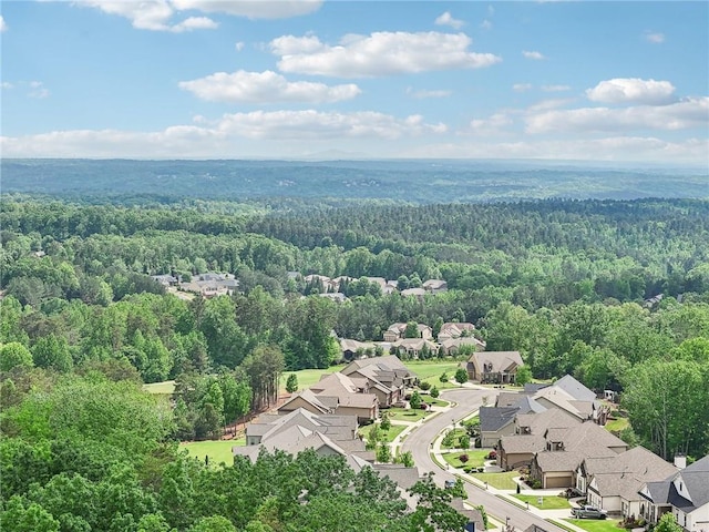 aerial view featuring a residential view and a wooded view