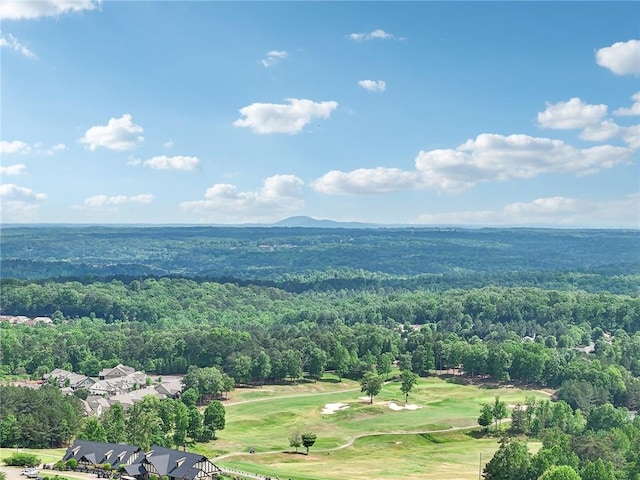 aerial view featuring view of golf course and a forest view