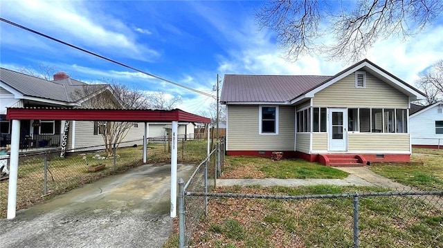 view of front of house with crawl space, a sunroom, and fence