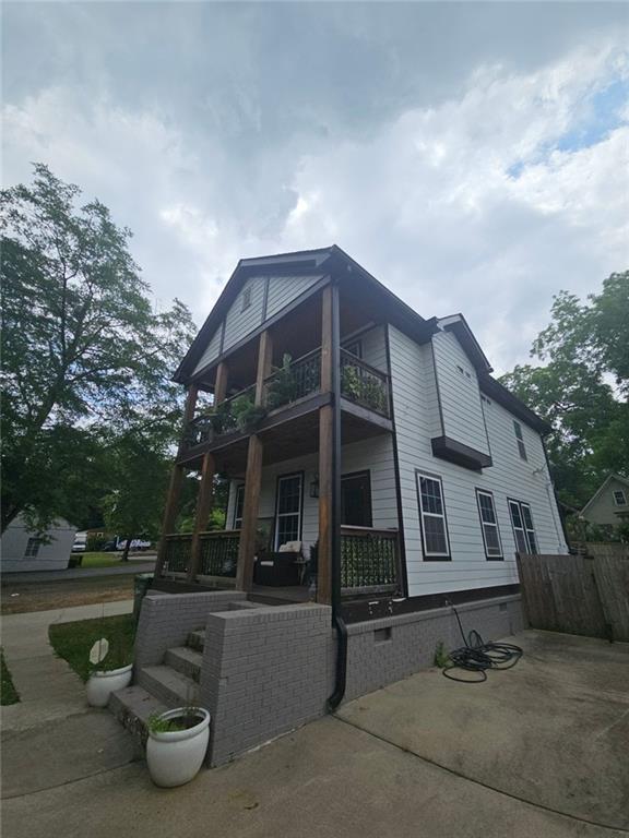 1228 Ladd St SW, Atlanta, GA 30310 - back of property featuring a balcony, fence, and a porch