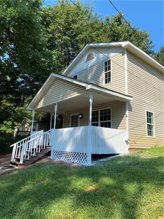 exterior space with a front lawn and a porch