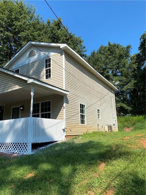 view of side of property with a yard