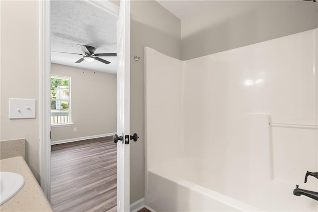 201 Rustin Dr, Dallas, GA 30157 - full bathroom with ceiling fan, wood finished floors, baseboards, vanity, and shower / bathtub combination