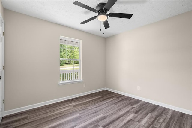 201 Rustin Dr, Dallas, GA 30157 - spare room featuring baseboards, dark wood-style floors, and a textured ceiling