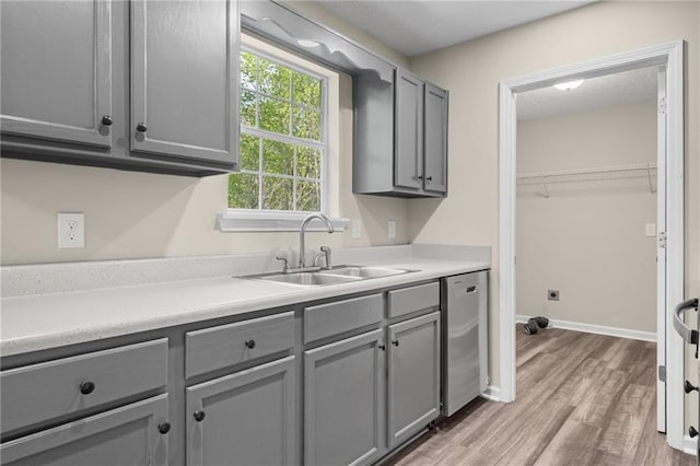 201 Rustin Dr, Dallas, GA 30157 - laundry room featuring a sink, baseboards, and light wood-type flooring